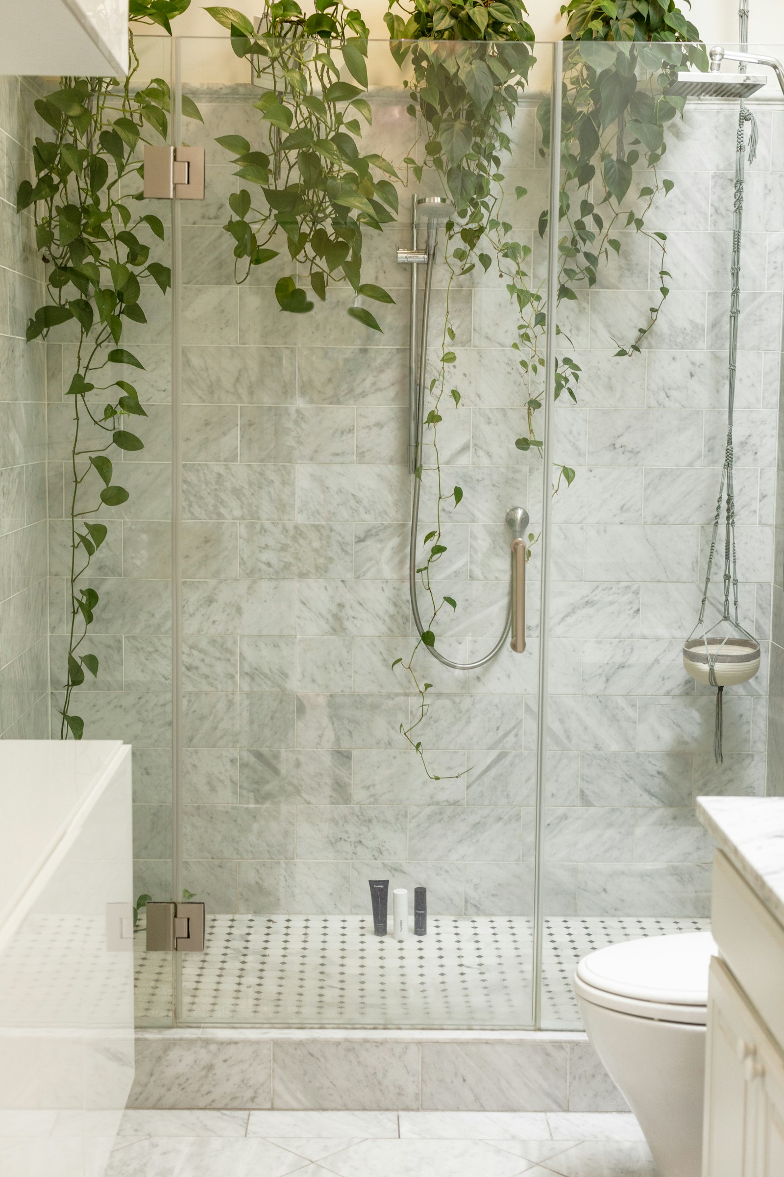 A walk-in shower enclosed by a frameless glass screen.