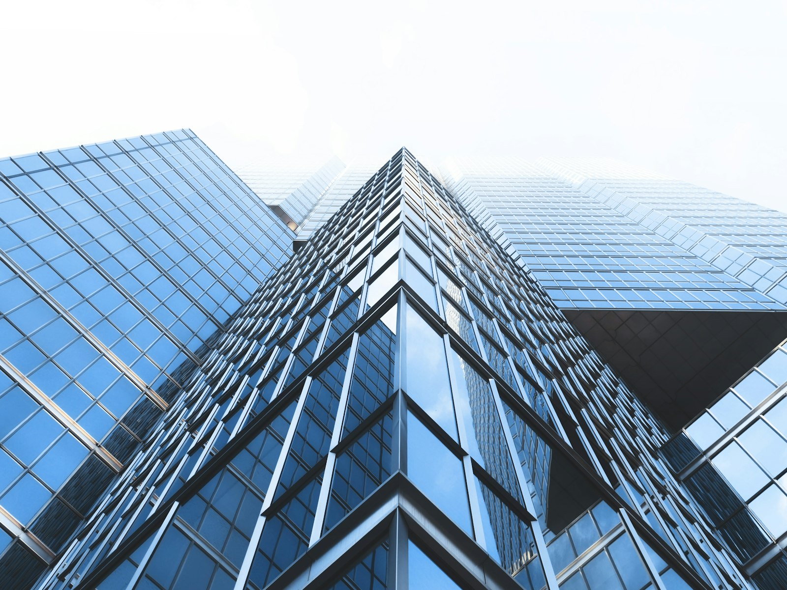 Curtain-wall glazing on a high-rise, seen from below.