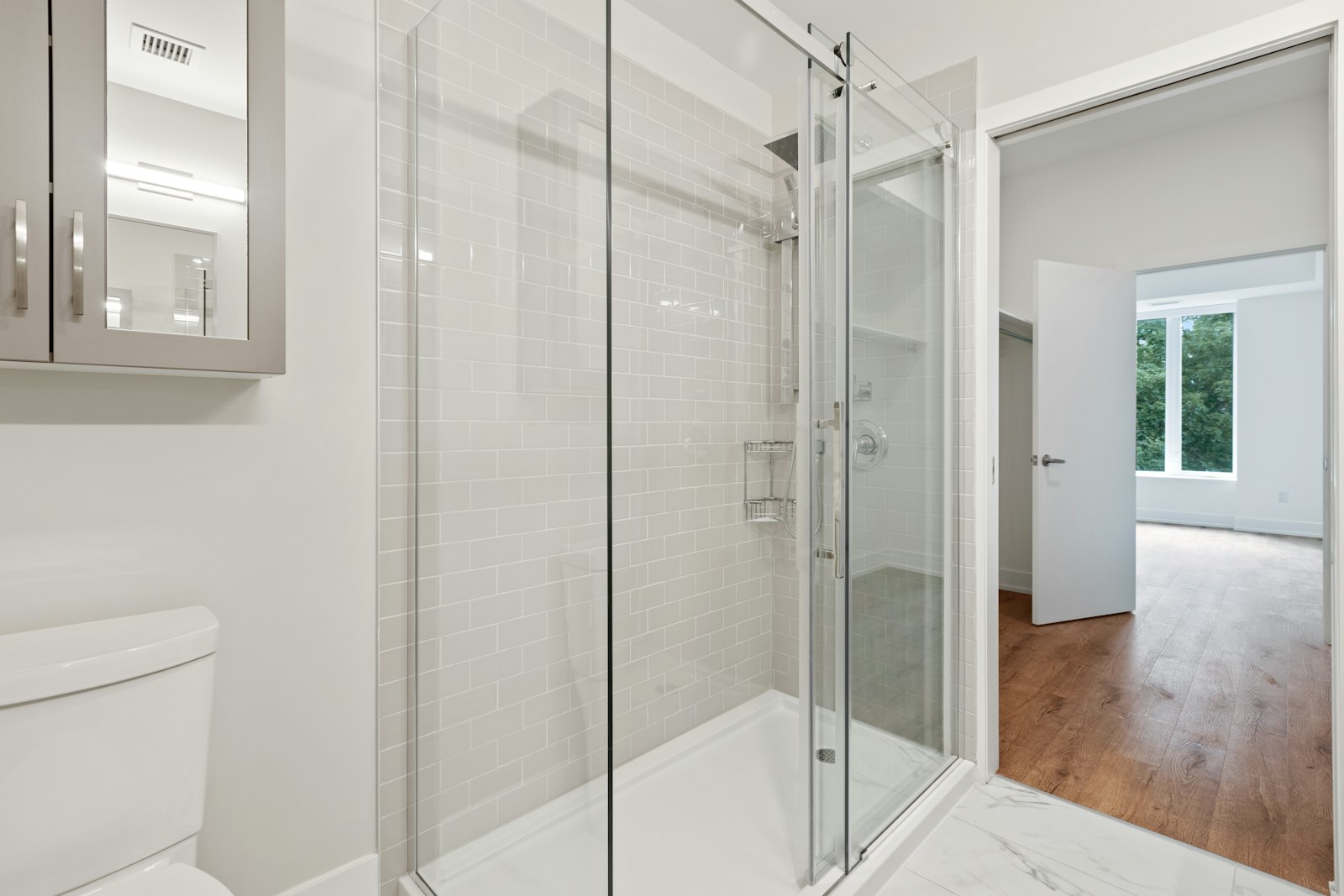 A clear glass door with a slim frame in a bright interior.