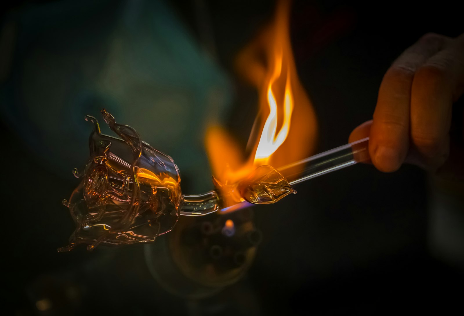 A glass piece handled by hand during finishing.