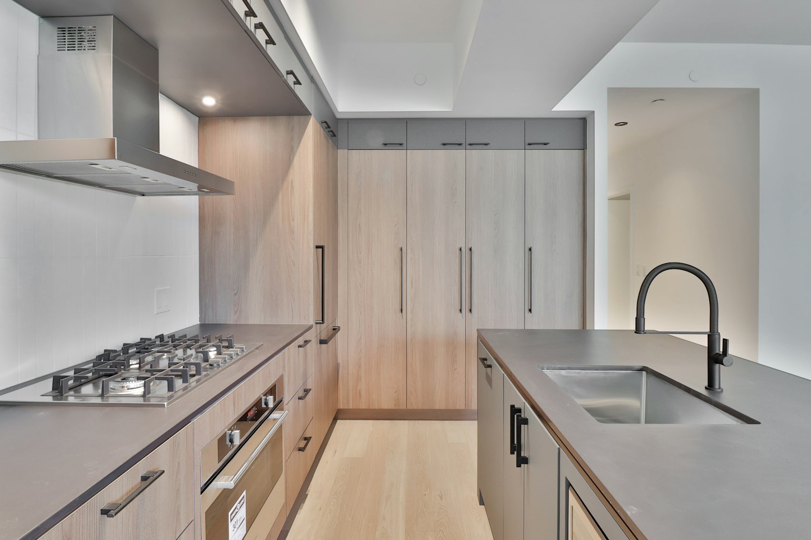 A cooktop set against a continuous splashback panel.